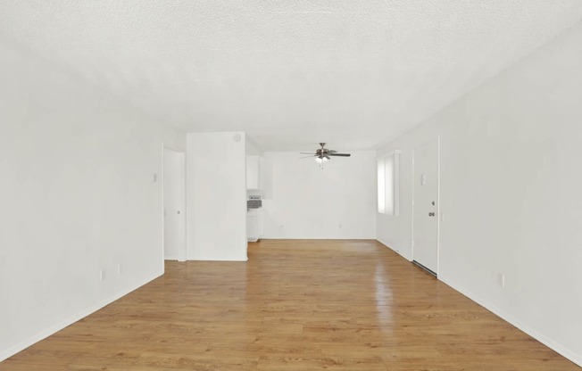 an empty living room with white walls and a ceiling fan at Casa Del Amo Apartments, California, 90505