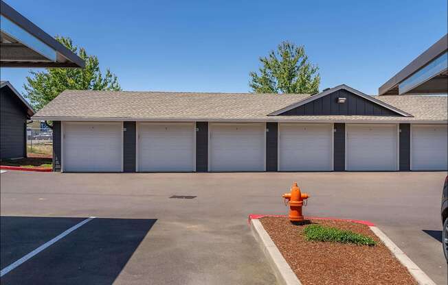A fire hydrant is in front of a garage at Riverplace Apartment Homes, Independence, OR, 97351