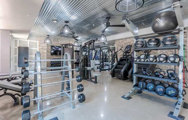 A well-equipped home gym with various fitness machines and weights.