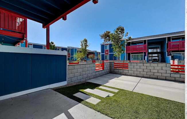 A blue building with a red awning and a white sign with a red border.