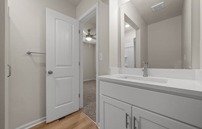 a bathroom with a large mirror and a white sink