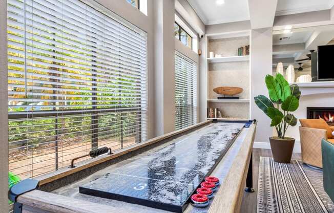 a large hot tub in a living room with large windows