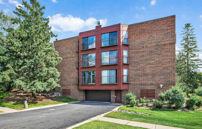 A red brick building with a garage door and windows.