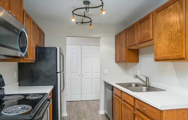 a kitchen with wood cabinets and white countertops
