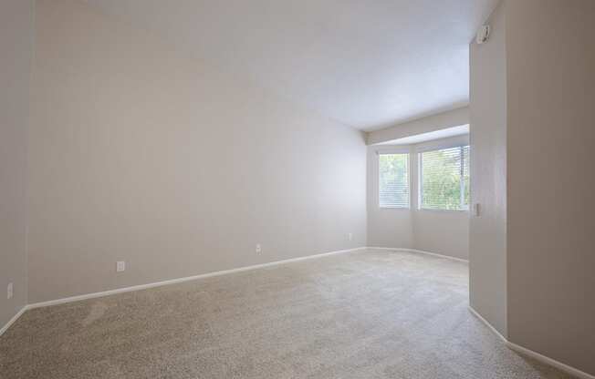 A room with a carpeted floor and a door leading to a balcony. at Harbor Pointe, California