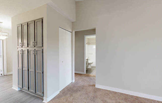 A room with a white wall and a carpeted floor.