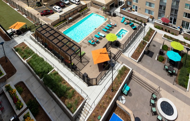 an overhead view of a swimming pool in the middle of an apartment building