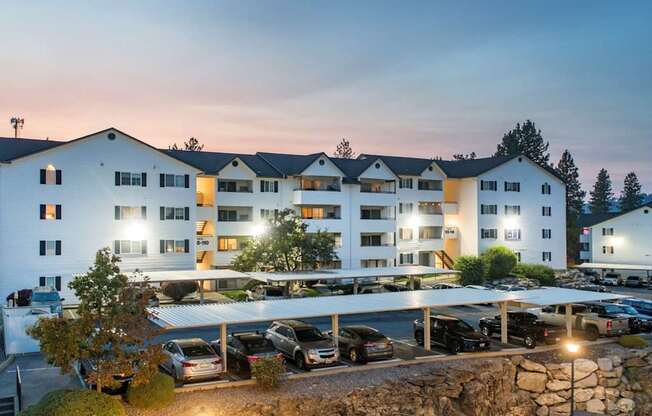 A large white building with a parking lot in front of it.