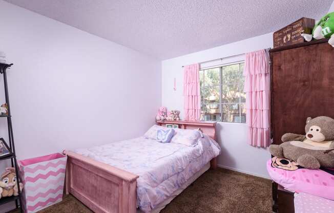 a bedroom with a bed and a dresser and a window