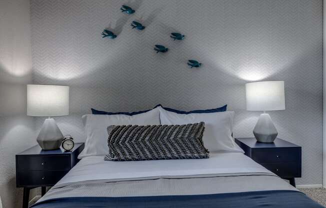 a bedroom with a bed and two night stands with lamps