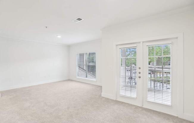 Spacious living room with big windows and natural light