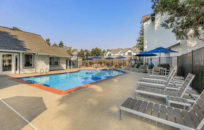 a wooden bench sitting next to a pool