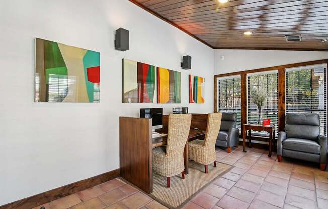 A room with a wooden bar and chairs.