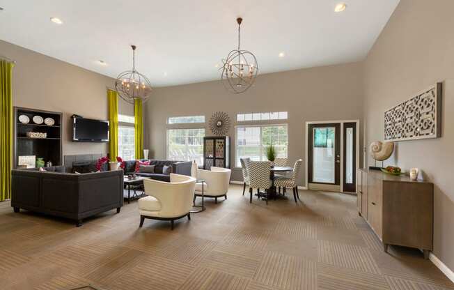 Clubhouse with Contemporary Fixtures and Decorations and Dining Table with Chevron Print Chairs Next to White Armchairs