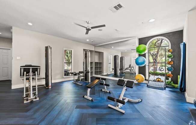 a home gym with exercise equipment and a large window
