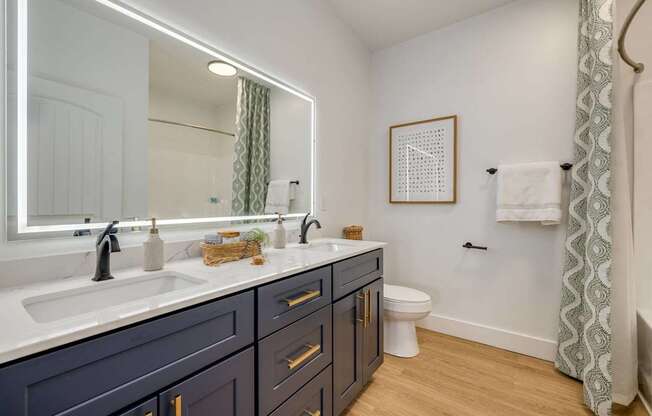 A bathroom with a white sink and a mirror.