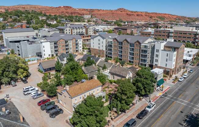 an aerial view of apartments in a city with a mountain in the background