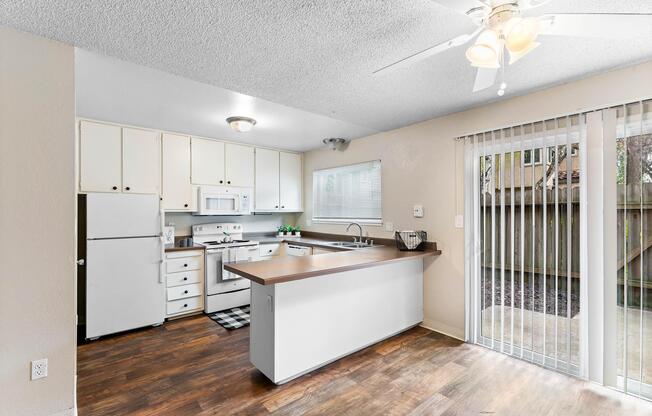 a kitchen with a stove top oven sitting inside of a room