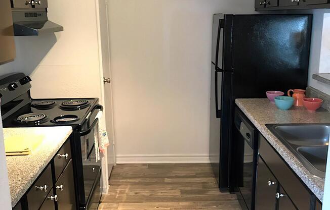 a kitchen with a stove sink and refrigerator