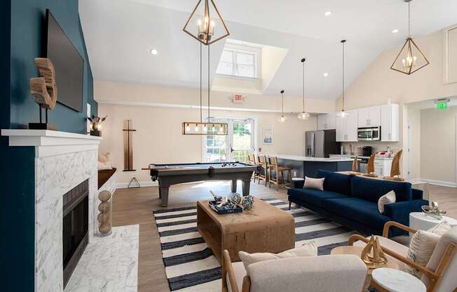 A living room with a pool table and a fireplace.