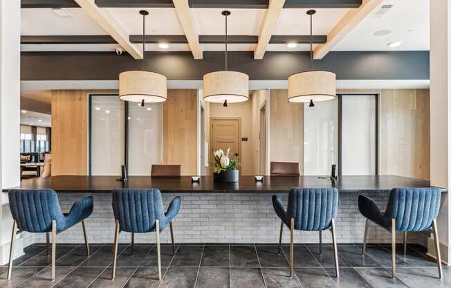 a large table with blue chairs in a lobby