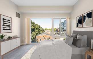 a bedroom with a bed and a large window at Residences at Manchester Place in Manchester New Hampshire
