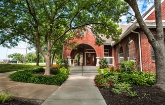 a brick building with trees in front of it