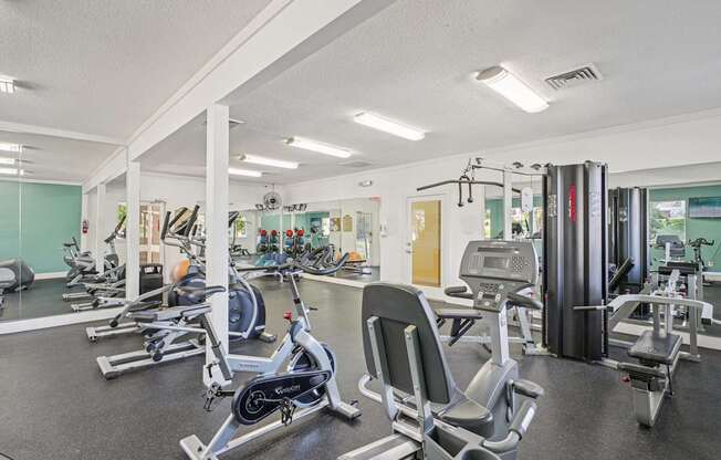 A gym with a row of exercise bikes.