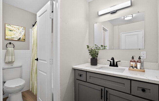 Elevate your living standards at Merrill House Apartments, where modern design meets comfort. This beautifully designed bathroom features elegant fixtures and ample lighting, perfect for your daily routine. Schedule a tour today!