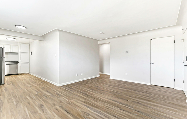 Bright and airy apartment with sleek laminate flooring, an elegant open floor plan, and a modern kitchen layout.