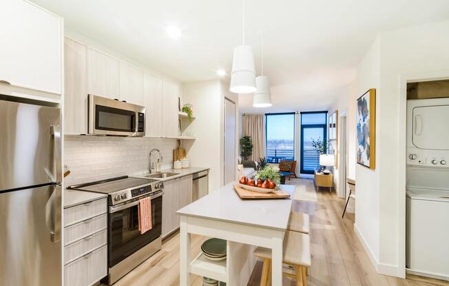 An open kitchen with refined finishes, in-home laundry, and a seamless flow into your living space.