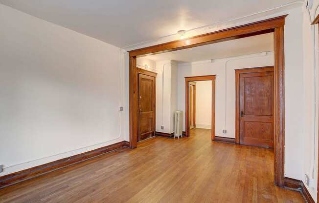 a renovated living room with wood floors and white walls