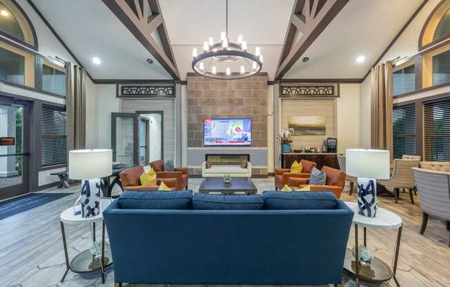 a living room with a blue couch and a television