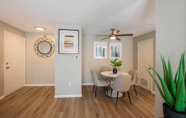A dining room with a table and chairs.