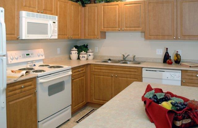 a kitchen with a white stove top oven next to a counter