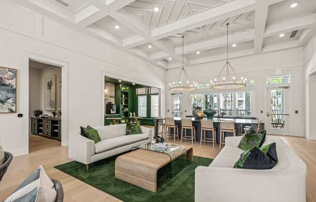 the living room has a coffered ceiling and a dining room with a large table