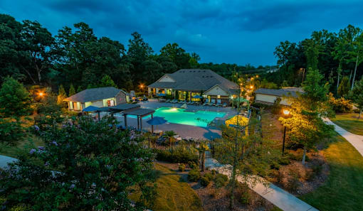 a mansion with a large swimming pool at night at Echo at Lake Norman, Mooresville