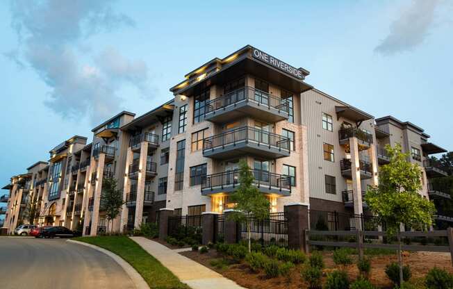 an apartment building with a sidewalk in front of it  at One Riverside Apartments, Chattanooga, TN, 37403