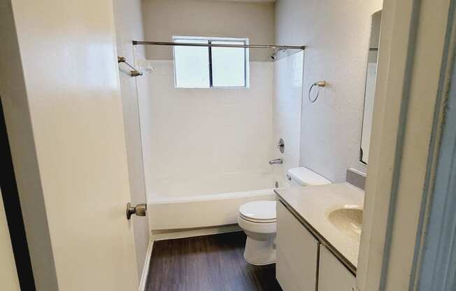 an empty bathroom with a toilet and a sink