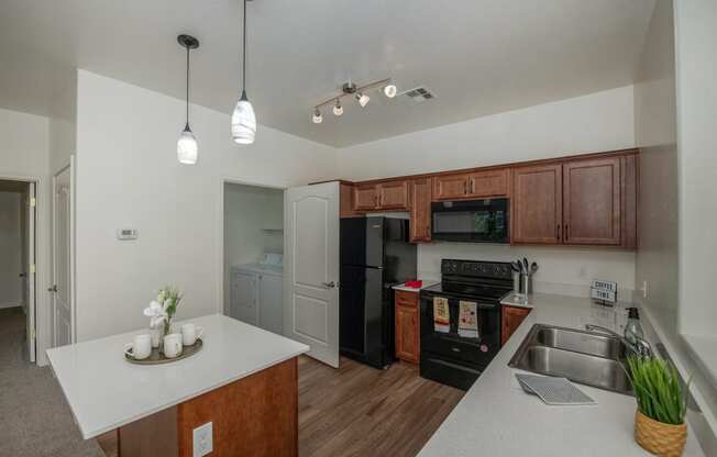 a kitchen with black appliances and a white counter top