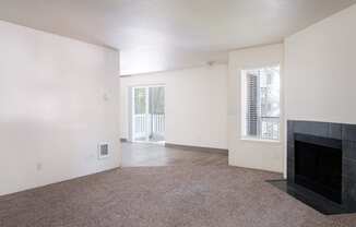 a living room with white walls and a fireplace