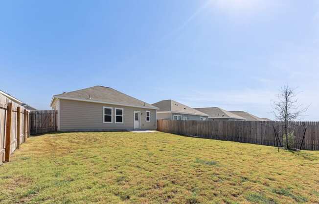 Backyard with a grassy area for outdoor activities of Dogwood floor plan at Beacon at Presidential Heights in Manor, TX