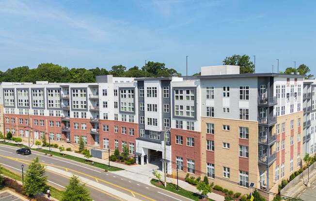 A row of modern apartment buildings with trees in the background.