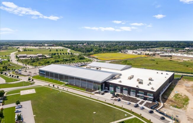 A large building with a parking lot in front of it.