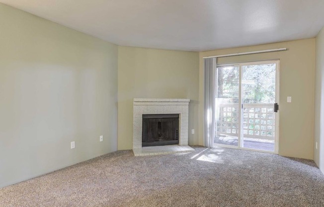 Cascadia Pointe Apartments in Everett, Washington Living Room with Fireplace and Private Patio
