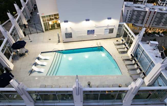 a view of the pool from the top of a building