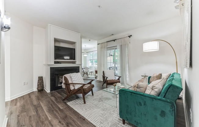 a living room with a green couch and a fireplace