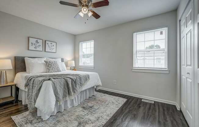 a bedroom with a bed and a ceiling fan