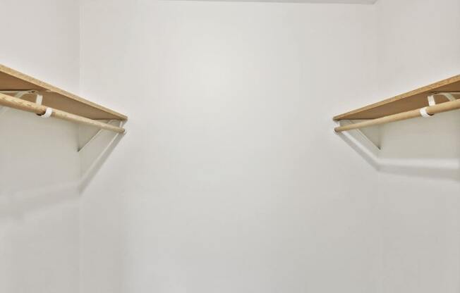 a room with two shelves on the wall and a carpeted floor