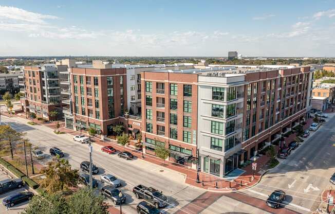 A street view of a city with cars and buildings.